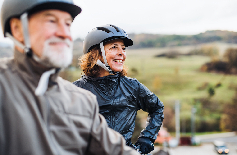 An active senior couple goes on a bike ride