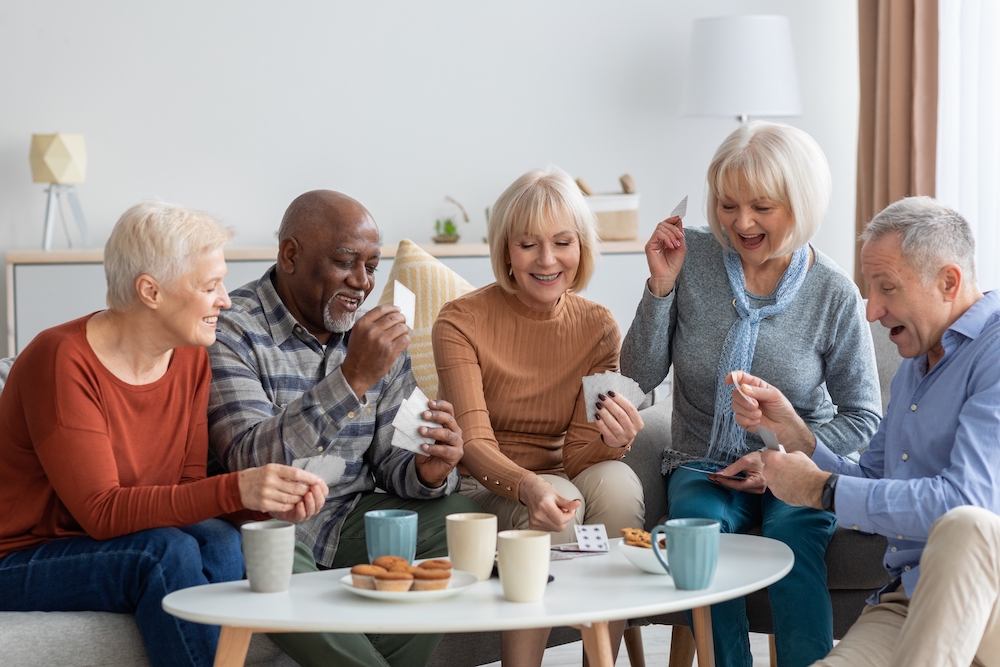  A group of senior friends playing cards together