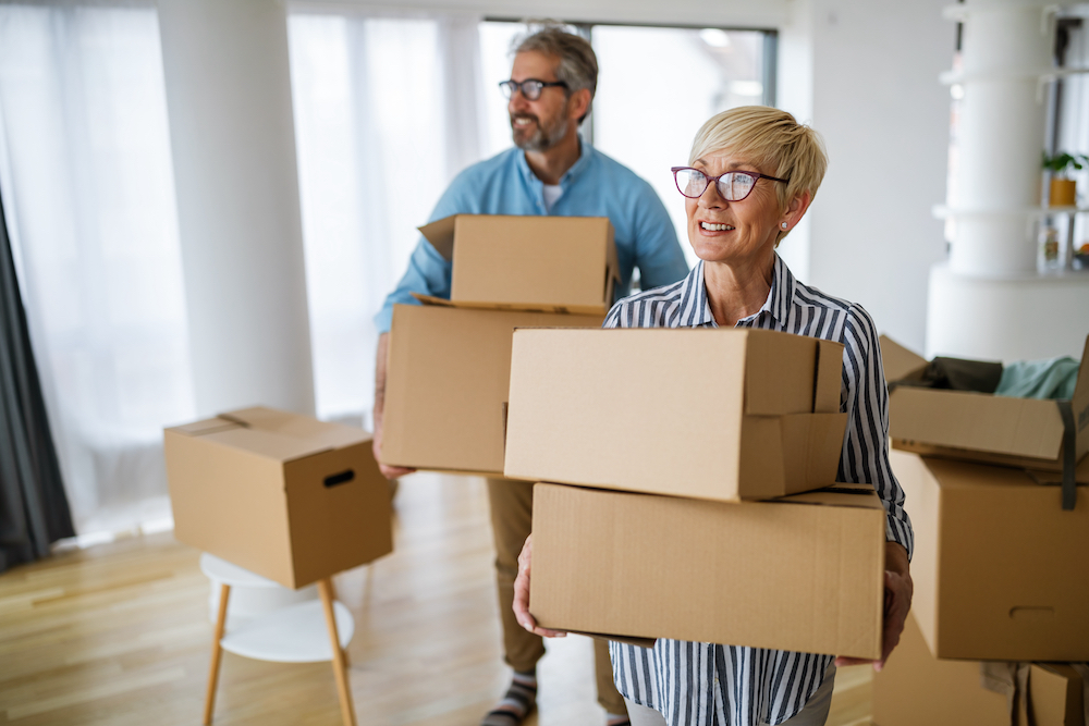 A happy senior couple with moving boxes