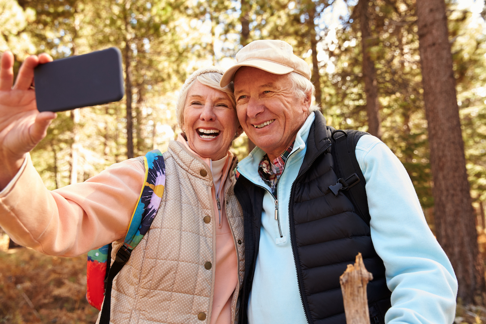 A senior couple on a hike outdoors