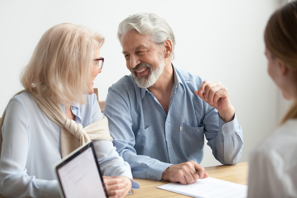 A happy senior couple researching senior living apartments