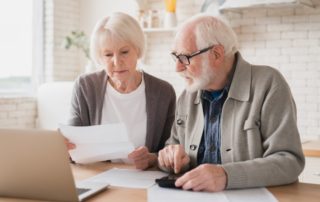 A senior couple calculates the cost of moving to senior independent living in Michigan