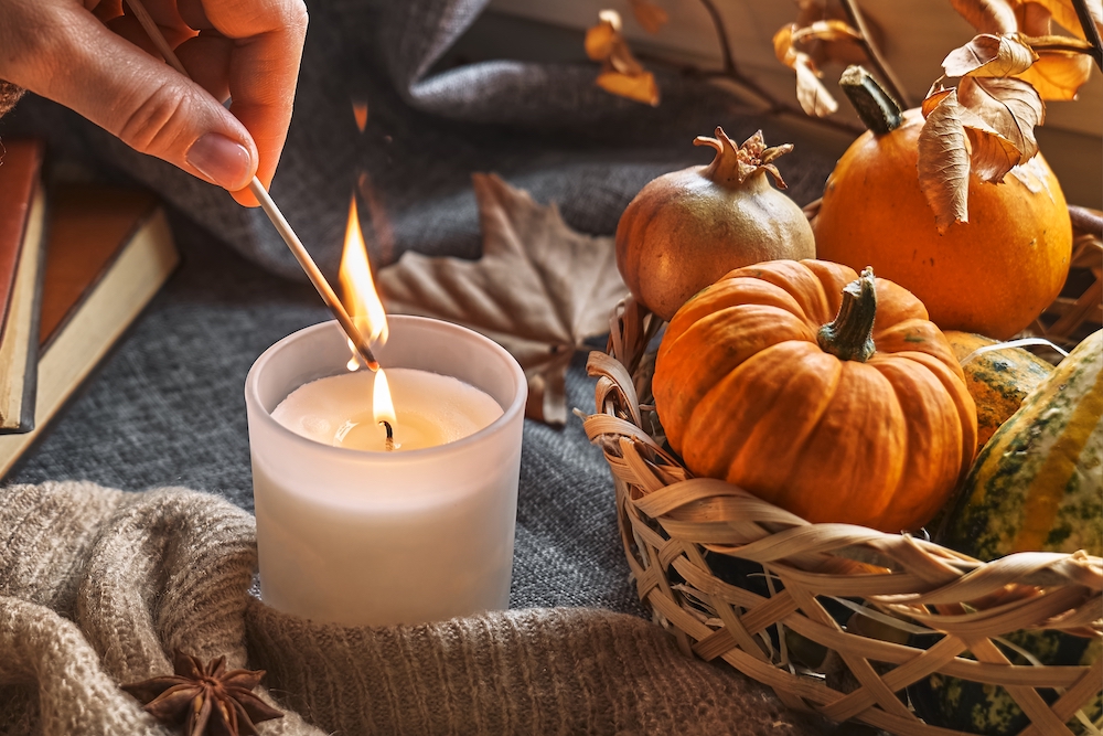 A senior lighting a fall candle 