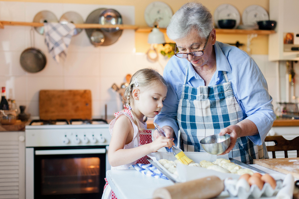 A senior woman and her granddaughter bake together at the senior apartments in Madison Heights, MI