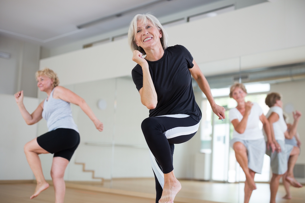 A group of senior woman participate in a dance class at the luxury senior living in Madison Heights, MI