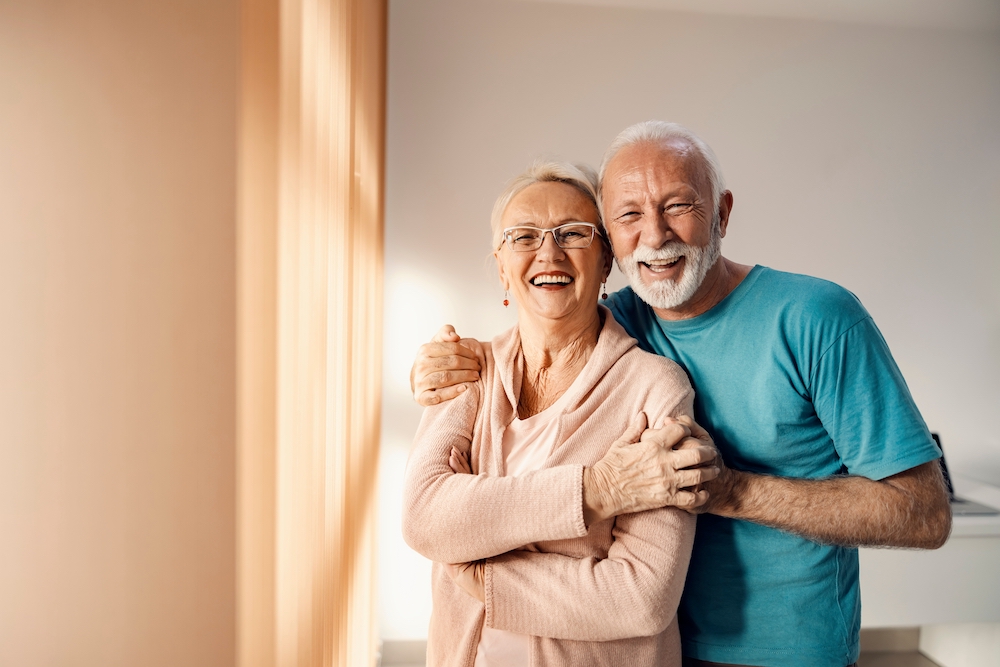 A happy senior couple laugh and smile at the senior independent living in Michigan