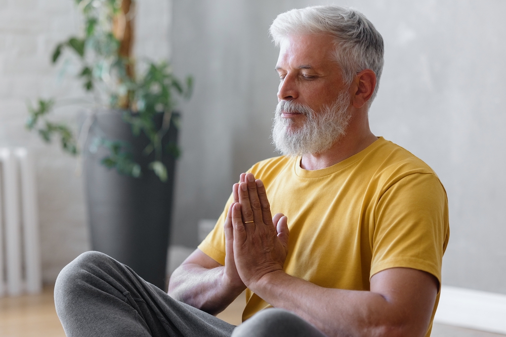 An active senior man practicing meditation at the senior independent living in Michigan
