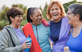 Four happy and active senior friends out on a walk together