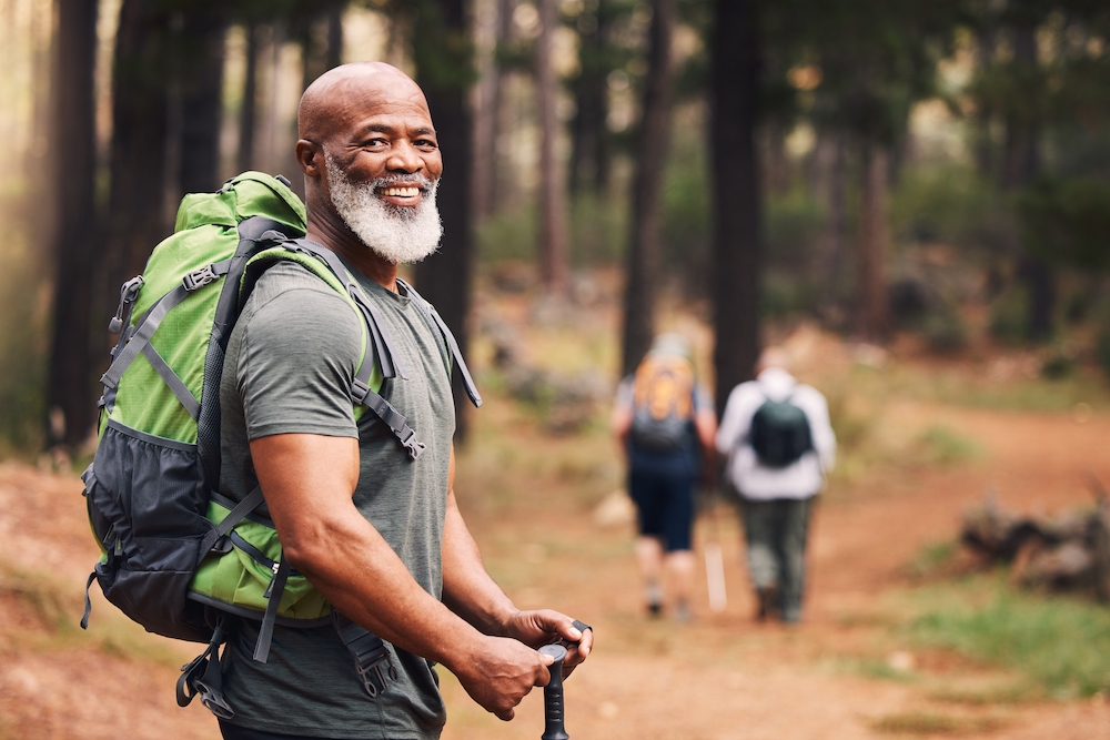A senior man out on a hike with friends