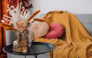 A coffee table with fall decor and flowers