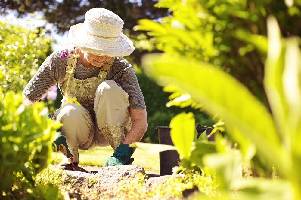 A senior woman working in a community garden