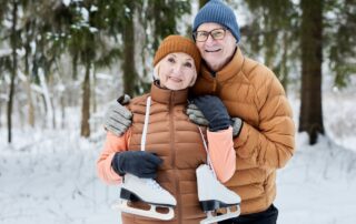 A senior couple getting ready to go ice skating in the winter