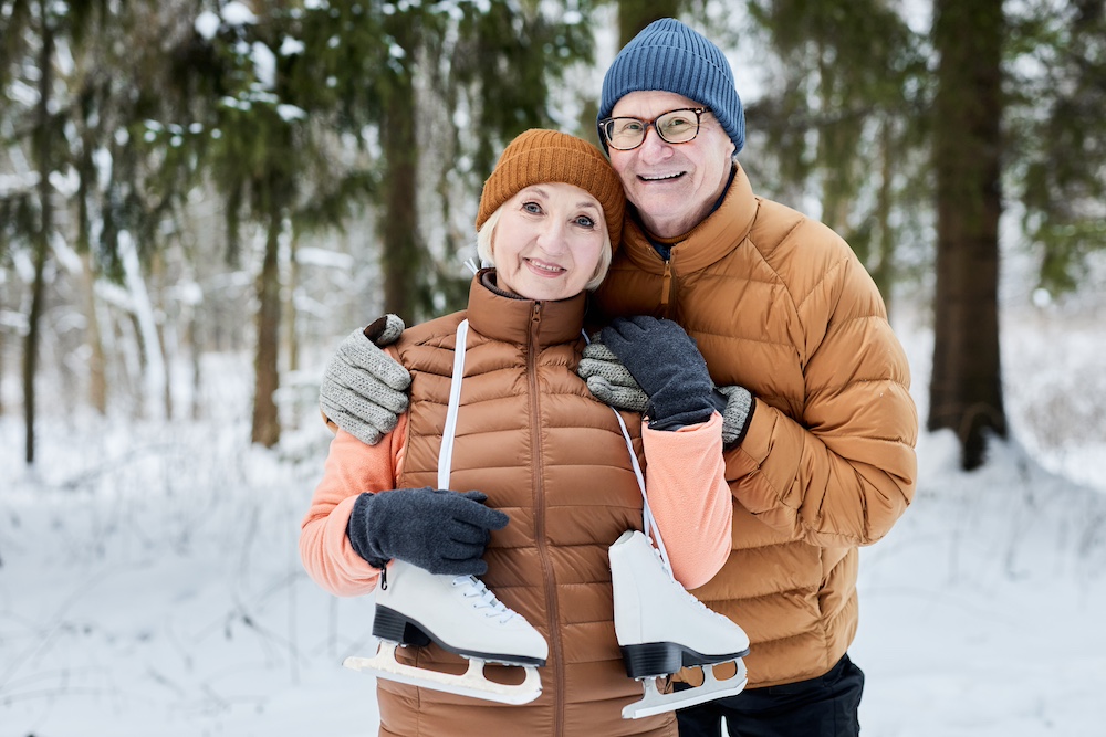 A senior couple getting ready to go ice skating in the winter