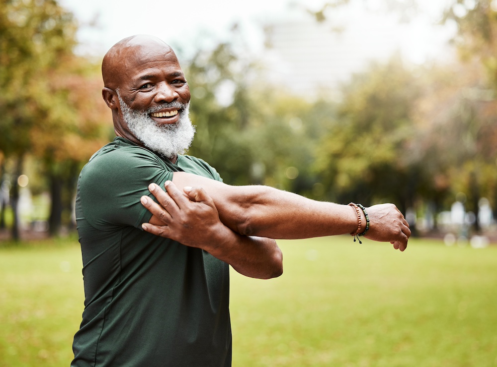 A senior man stretching before going for a run outdoors