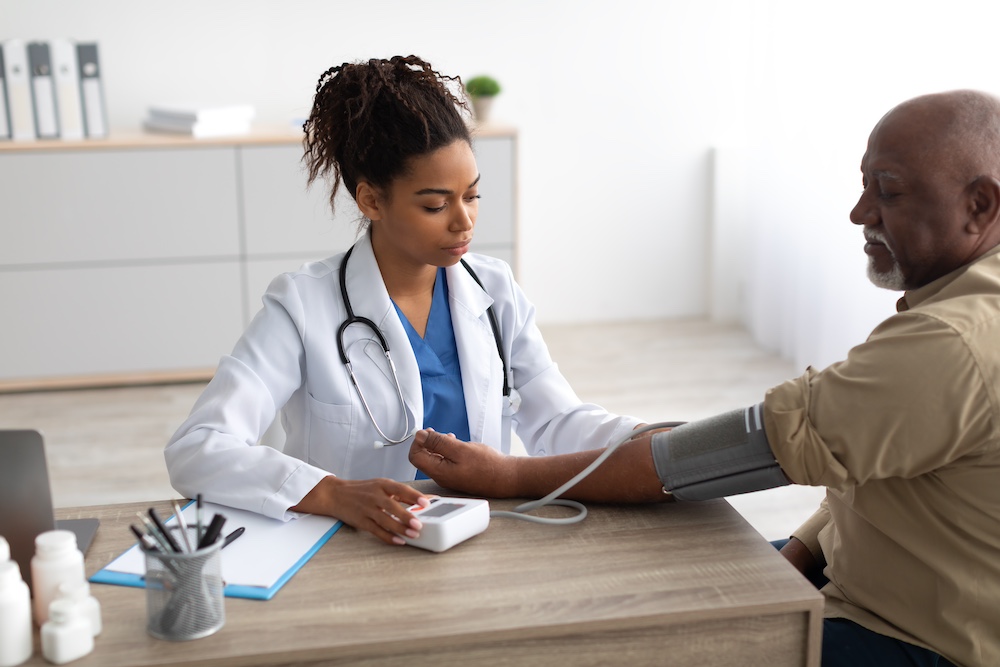 A doctor taking the blood pressure of a senior man