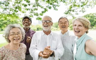 Five senior friends on a casual walk outside near the Madison Heights senior apartments