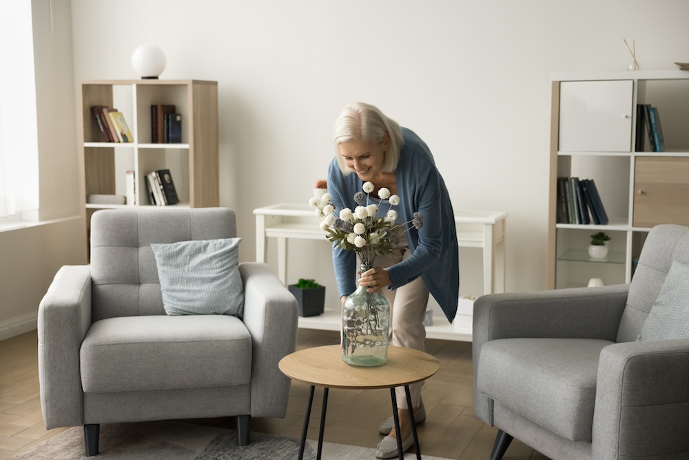 A senior woman decorating her space at the Madison Heights senior apartments