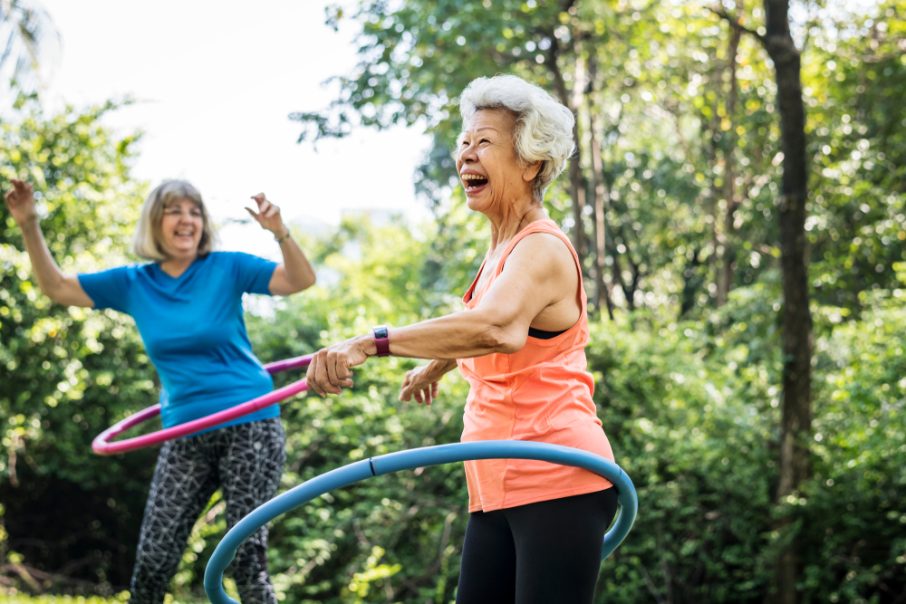 Woman hula-hooping near Madison Heights senior apartments.