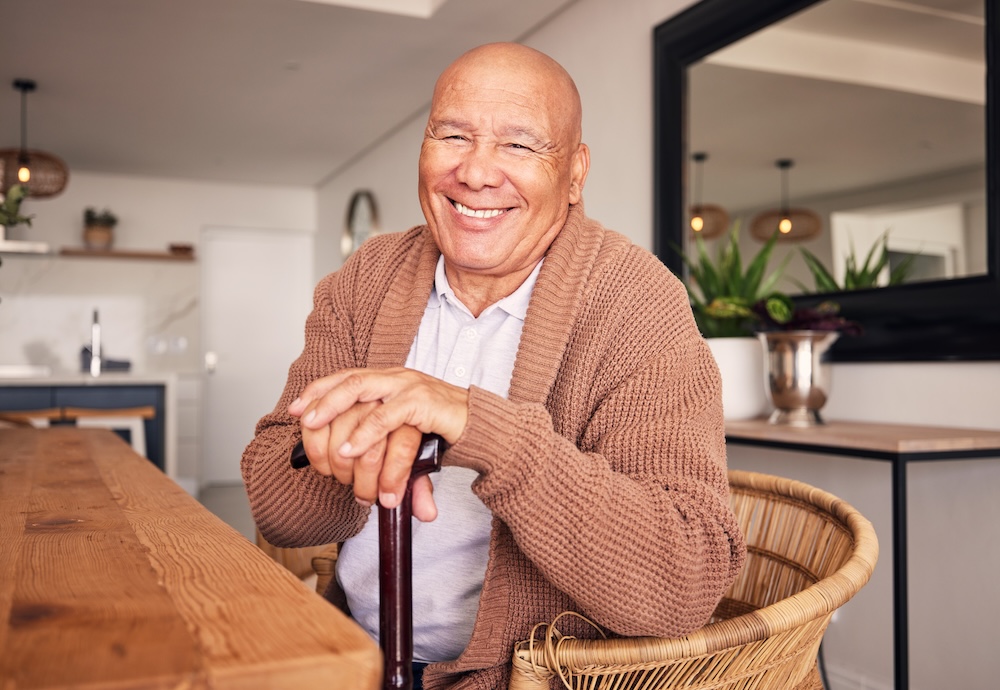 Older man sitting in chair with walking stick enjoying senior care sterling heights
