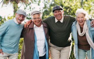 Group of seniors outside laughing and enjoying independent living for seniors