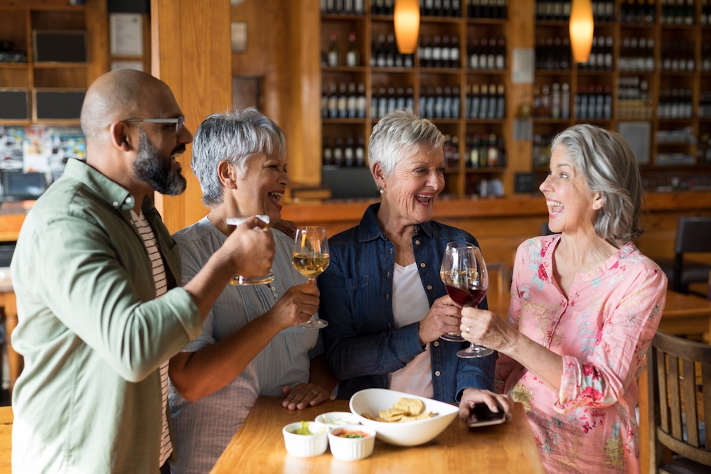 Group of seniors enjoying wine at a local senior living community madison heights