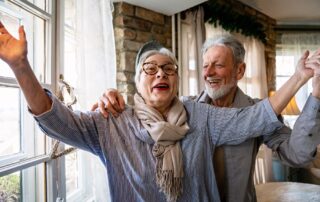 Senior couple inside happy and talking about independent senior living Michigan
